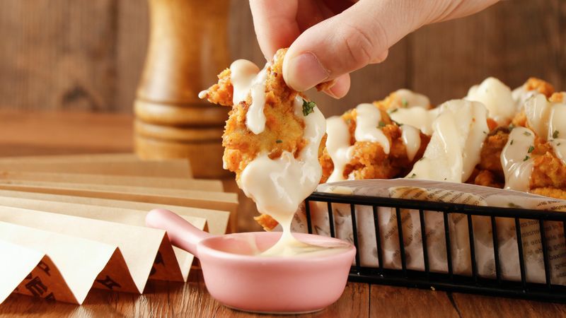 Hangry Joe's crispy chicken platter with fresh sides and dipping sauces